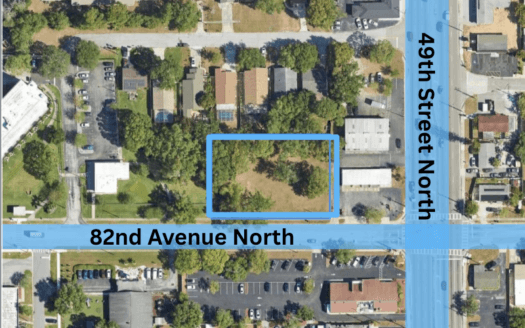 Aerial view of the intersection where 49th St. N. meets 82nd Ave N., showing a rectangular lot outlined in blue northwest of the intersection, now marked as SOLD.