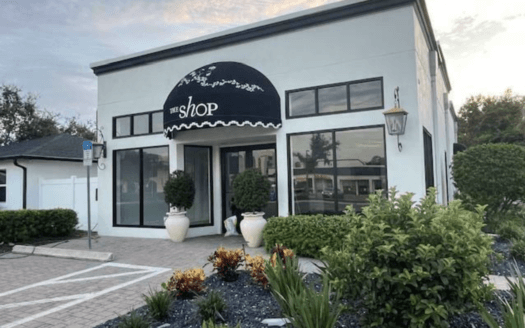 A small storefront with large windows, a black awning labeled "the shop," decorative plants, and a landscaped front area at 3440 4th St. N., St. Petersburg, FL 33704—recently sold in this vibrant neighborhood.