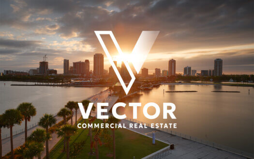 A city skyline at sunset over water with palm trees in the foreground; the "Vector Commercial Real Estate" logo is overlaid at the center.